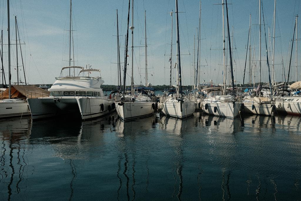 Yachts moored in a marina under a clear blue sky